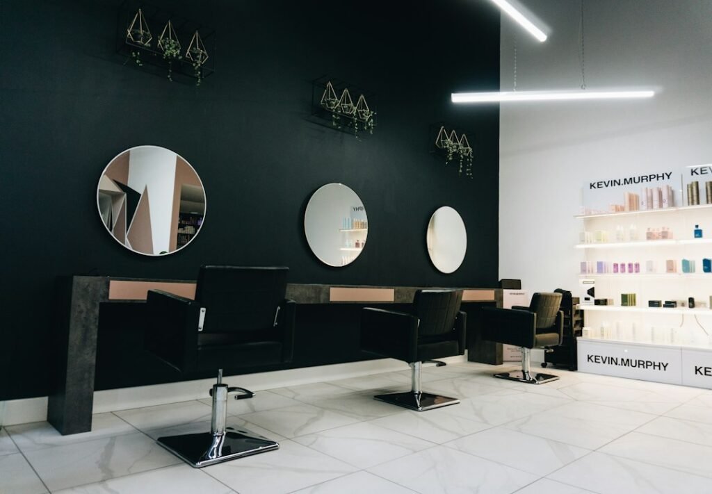 Modern hair salon interior with styling chairs and round mirrors