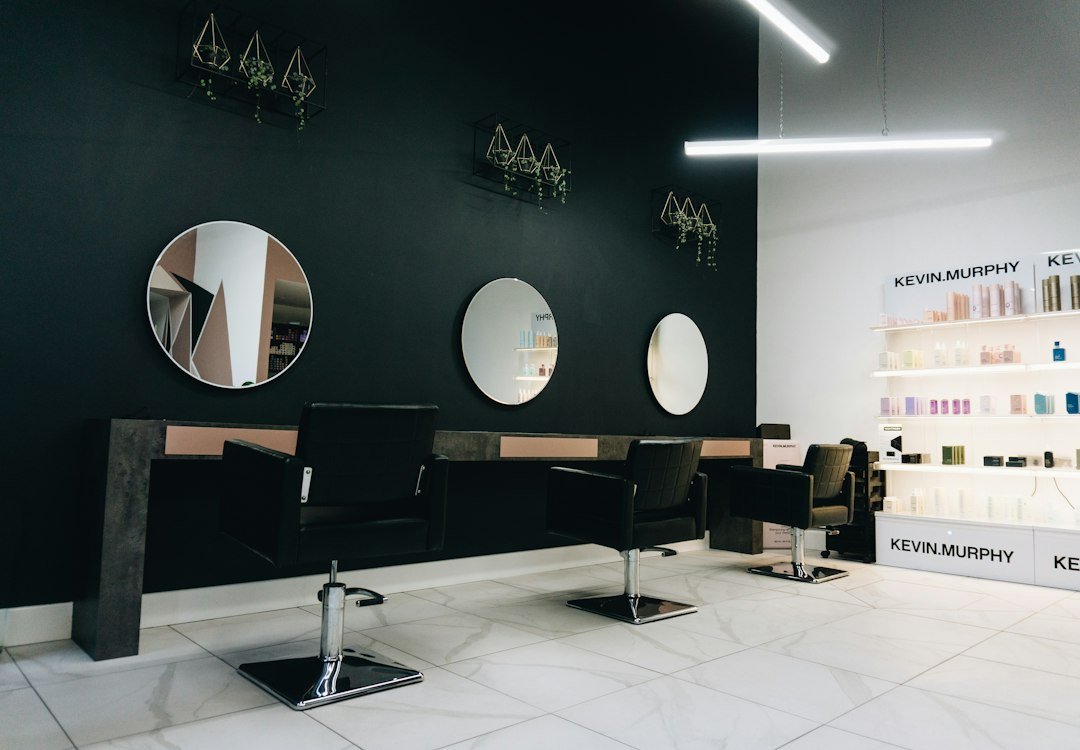 Modern hair salon interior with styling chairs and round mirrors
